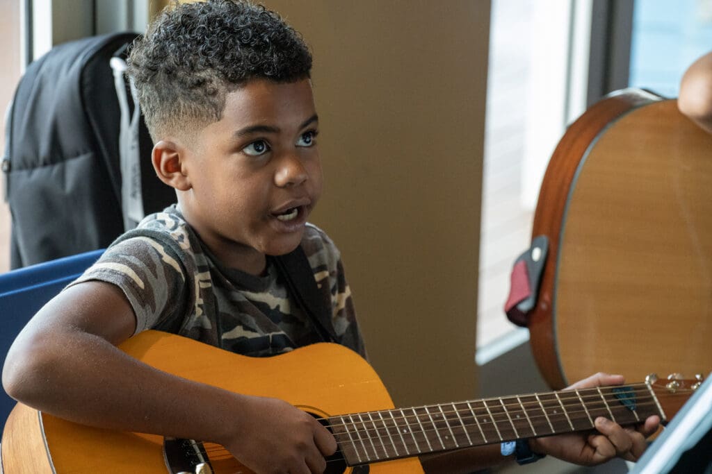 Child playing guitar.